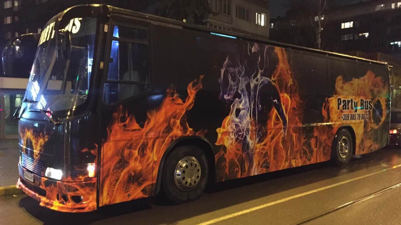 Sofia party bus with flame graphics at night