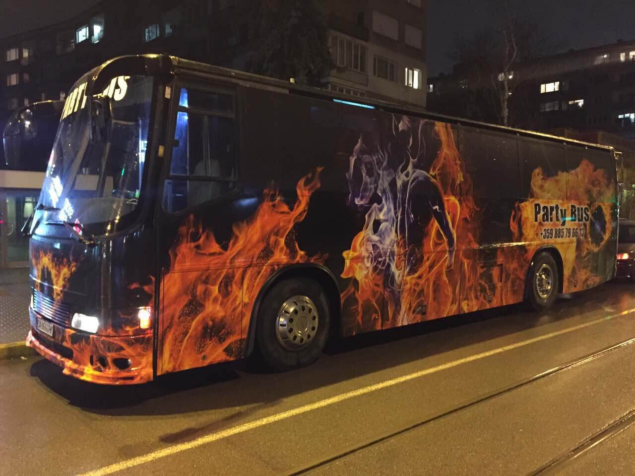 Sofia party bus with flame graphics at night