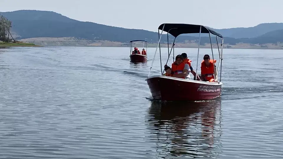 Two motorboats with canopies out on the reservoir