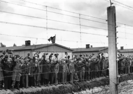 Archive photo of internees behind the barbed wire fence