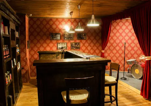 Bar counter and red curtains inside the Al Capone escape room in Sofia