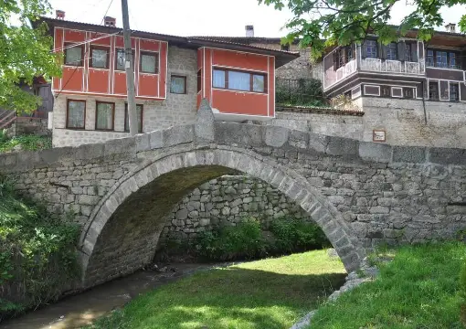 The stone bridge and green banks in Koprivshtitsa