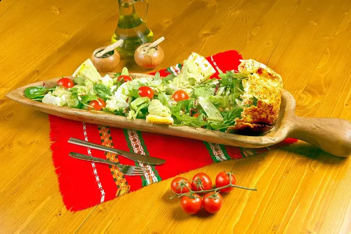 A Bulgarian salad served on a wooden plate
