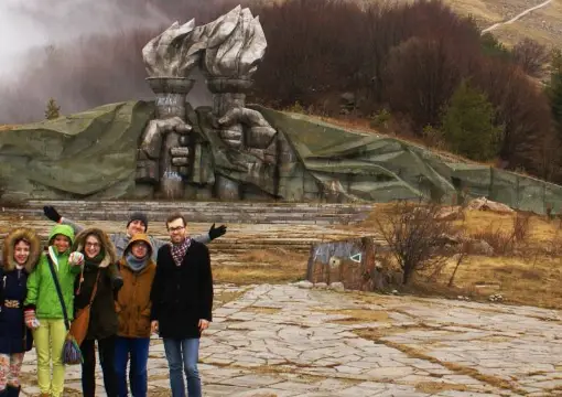 A tour group in front of the torch monument on the Buzludzha trip