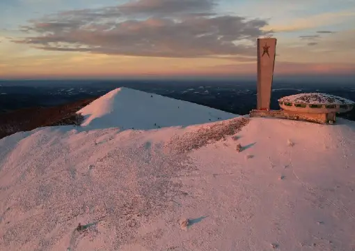 Buzludzha monument on its snowy peak at dusk