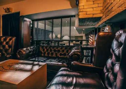 Leather Chesterfield armchairs upstairs at Caldo