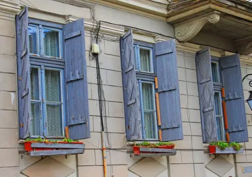 Blue shutters and window boxes on an old house in Plovdiv