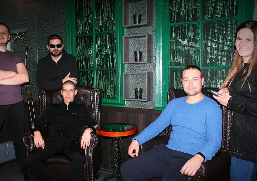 Team in leather armchairs inside the Matrix escape room in Sofia