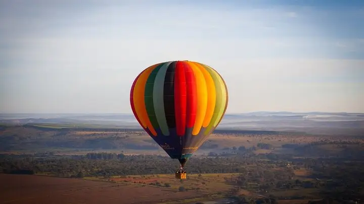 Hot air balloon at dawn over fields near Sofia