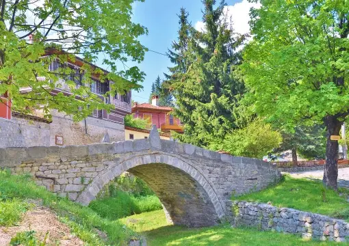 An old stone bridge over the river in Koprivshtitsa