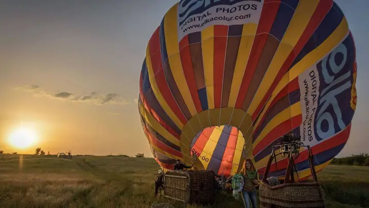 Hot air balloon being inflated at sunrise