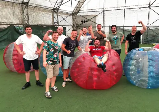 Group with red and blue bubbles on the covered pitch