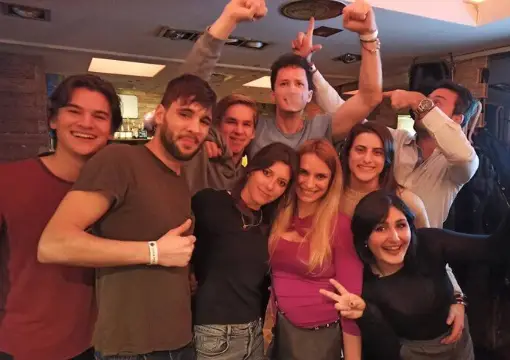 Group of friends with drinks in a bar on a Sofia pub crawl