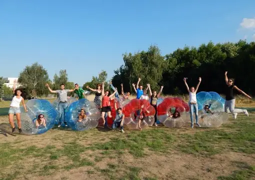 A group in bubbles cheering before a bubble football match