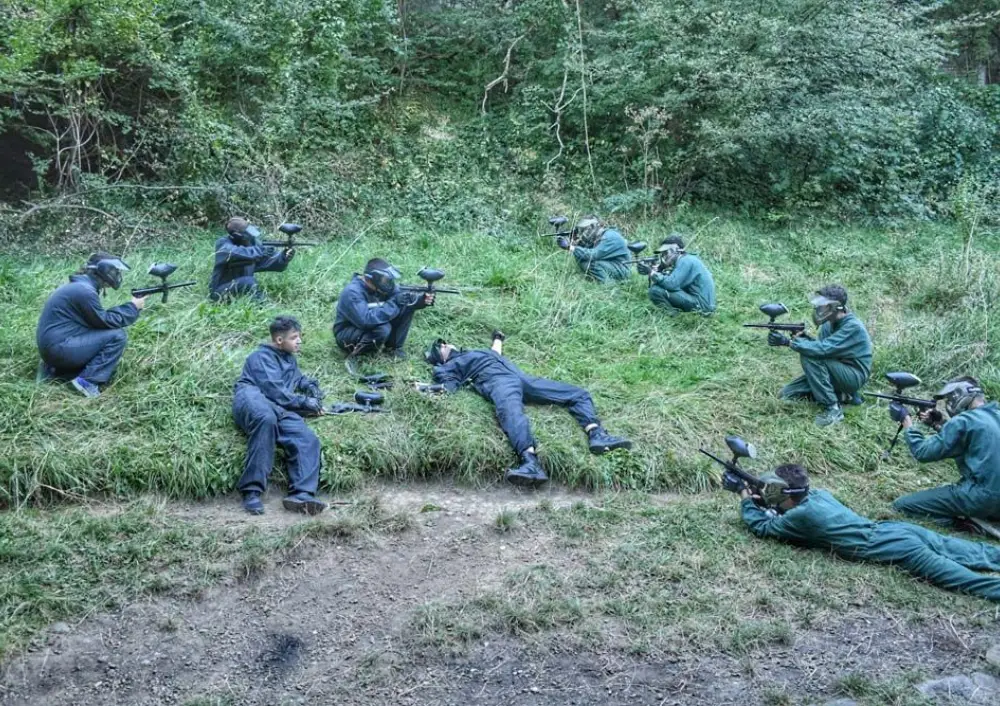 Two teams lying low in the grass before the start of a game