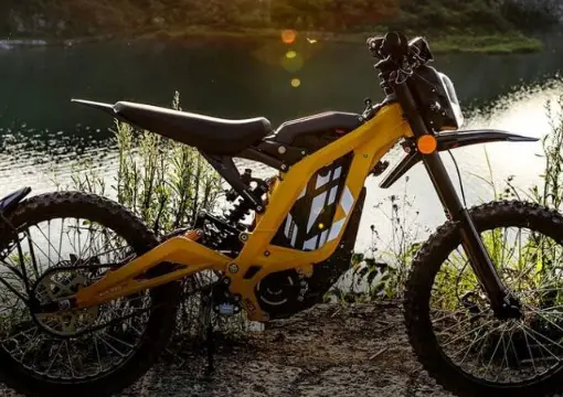 Sur-Ron electric motorbike parked by the water