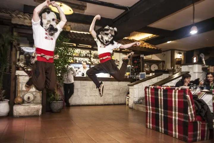 A folk dancer mid-jump during the show