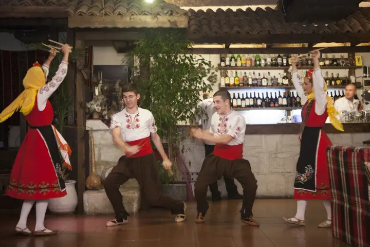 Dancers in red costumes on the dance floor