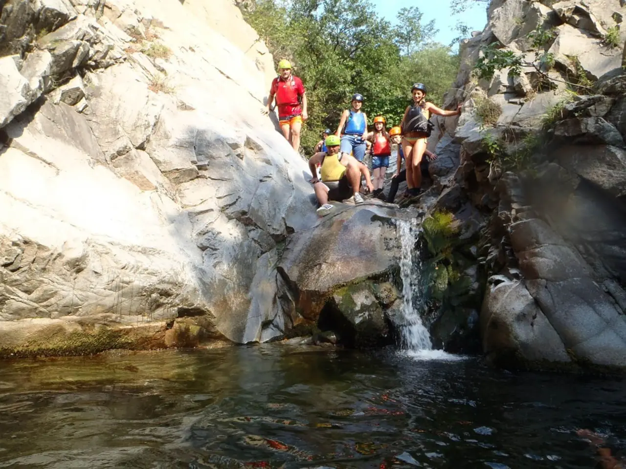 Group gathered by a small waterfall in the canyon