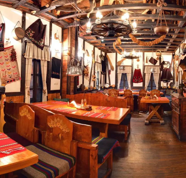 A dining room with folk textiles and woven tablecloths