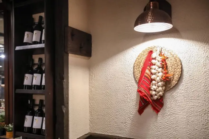 A garland of garlic and red peppers on the wall