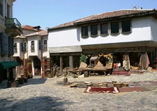 A white Revival house and its courtyard