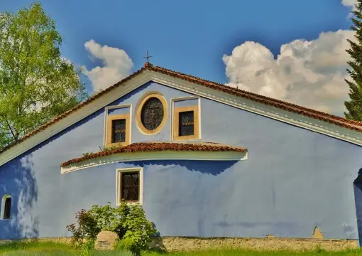 A blue painted building with a small tower