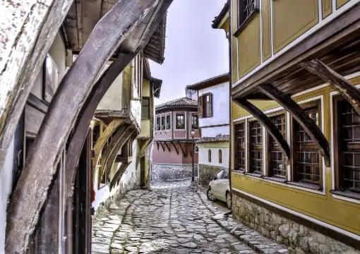 A narrow cobbled lane with wooden bay windows in Plovdiv