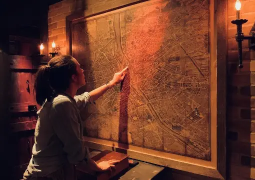 Player studying an old map by candlelight