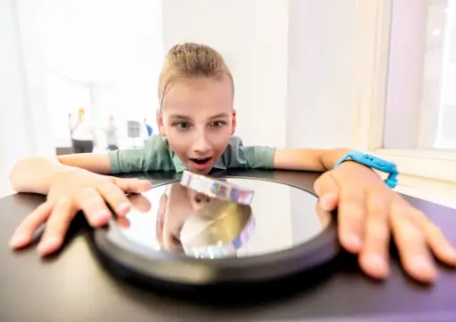 Girl looking into a mirror illusion