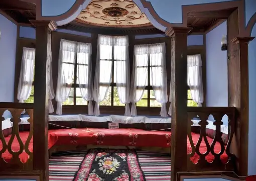 Inside a Revival house, with a window seat and red cushions