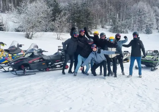 Friends celebrating after a snowmobile tour near Sofia
