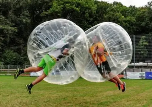 Two players flying through the air in clear bubbles