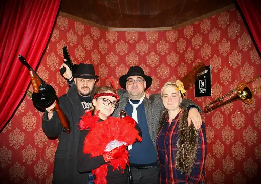 Group posing with prop guns after the mafia escape room