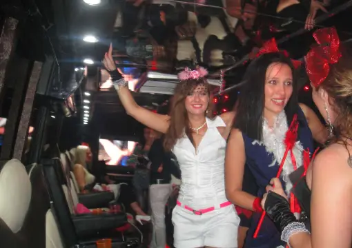 Hen party group dancing inside the party bus