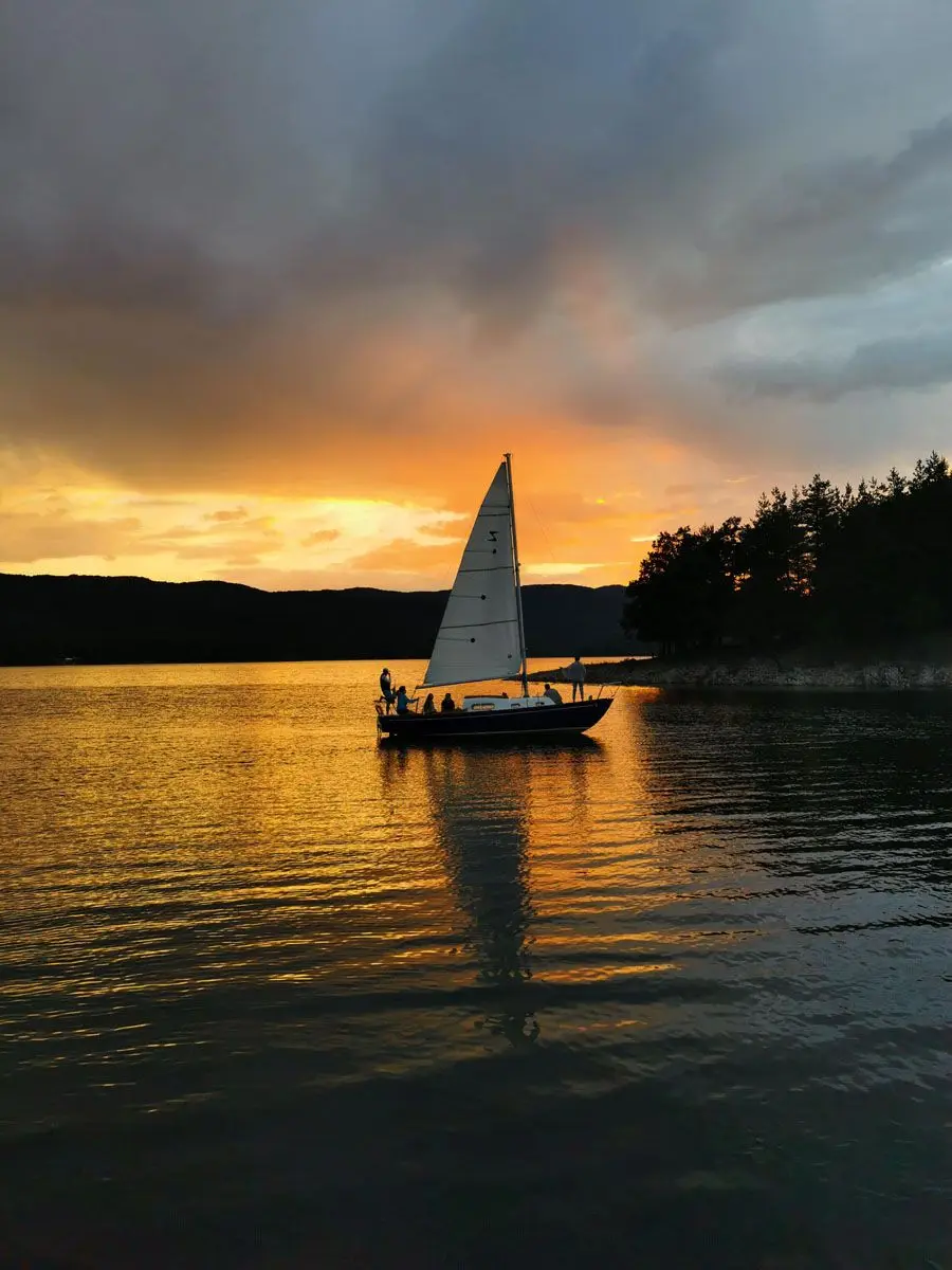 Sailing yacht on Iskar Reservoir at sunset