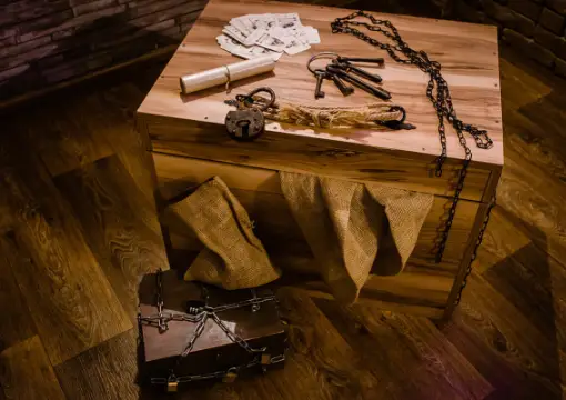 Old keys, ropes and a wooden box on the floor of The Trap escape room