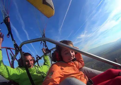 Father and son flying tandem in the paramotor trike