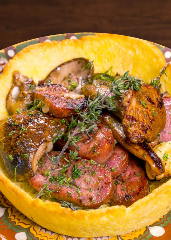 Roast meat with herbs on a wooden board