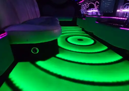 Limo seating area with green lit floor