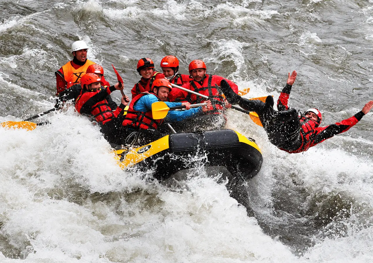Raft crew riding a rapid with paddles up on the Struma