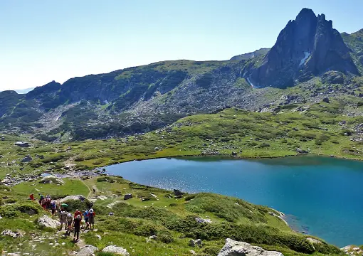 Lake below a rocky peak in the Rila Mountains