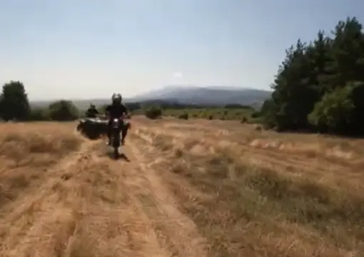 Guide riding ahead across an open field near Sofia