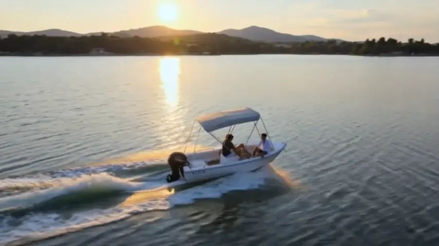 Motorboat with a sun canopy on Iskar Reservoir at sunset