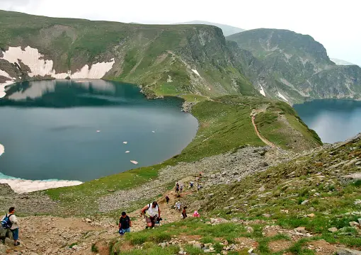 Snow on the shore of an upper Rila lake