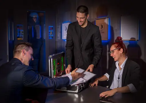 Team defusing the bomb together in the escape room