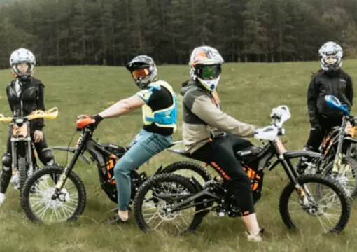 Group of riders with helmets and electric motorbikes before the ride
