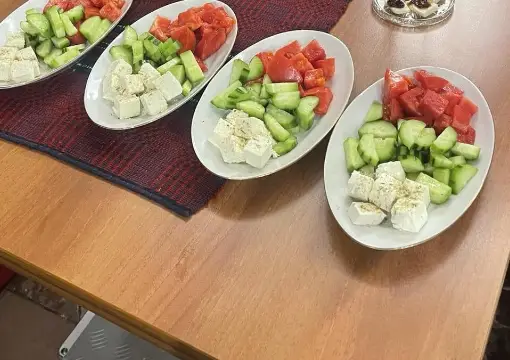 Plates of cucumber, tomato and white cheese served with rakia