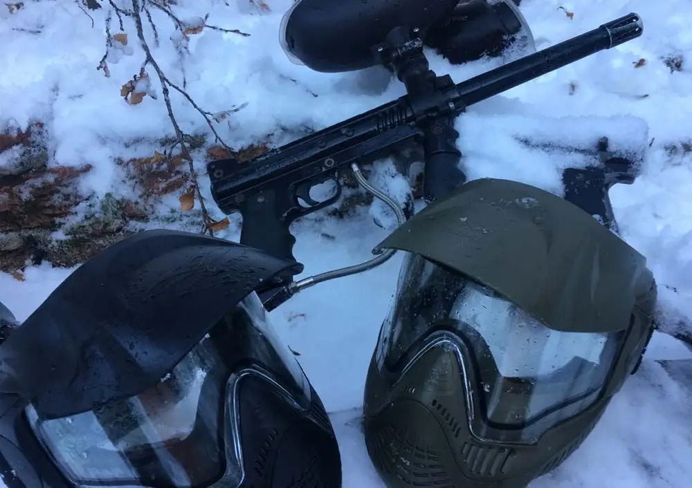 Paintball marker and masks in the snow