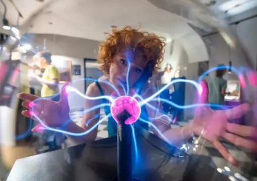 Visitor touching a plasma ball